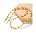A chain for glasses, beads, an orange pendant